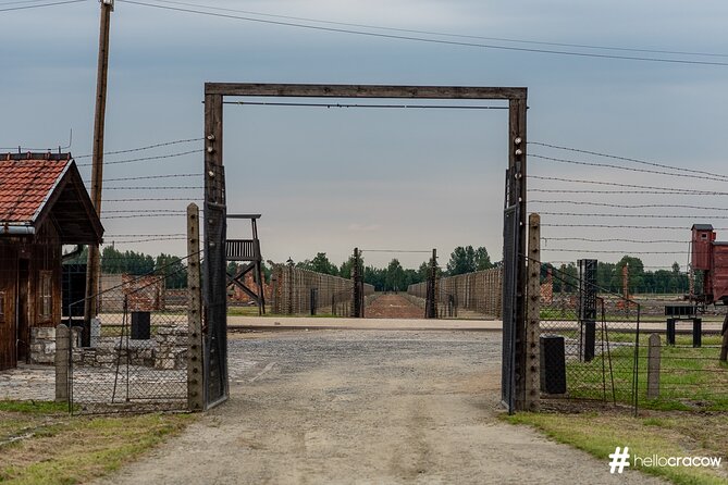 Auschwitz & Birkenau Guided Tour with Hotel Pickup from Krakow - Auschwitz I: Auschwitz I gate, Arbeit Macht Frei, and listening with headsets