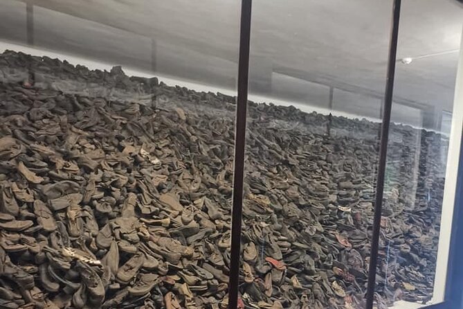 CV-Visit to the Auschwitz Camp in Italian with departure from Krakow - Auschwitz II, Birkenau: barracks, railway tracks, and crematoria remains